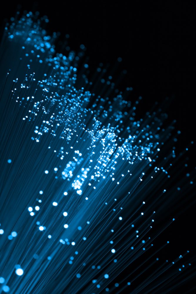 Fiber optic strands in cold blue tones, shallow DOF